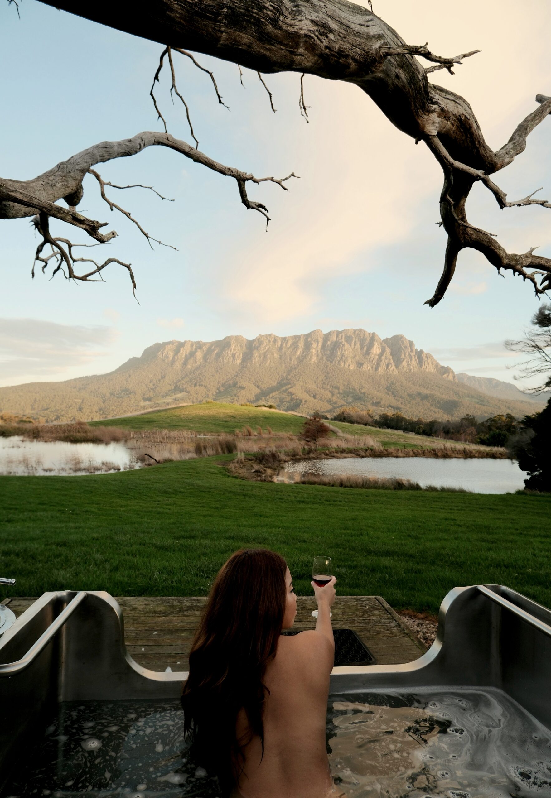 Guest enjoying an outdoor bath overlooking the mountains in North West Tasmania.