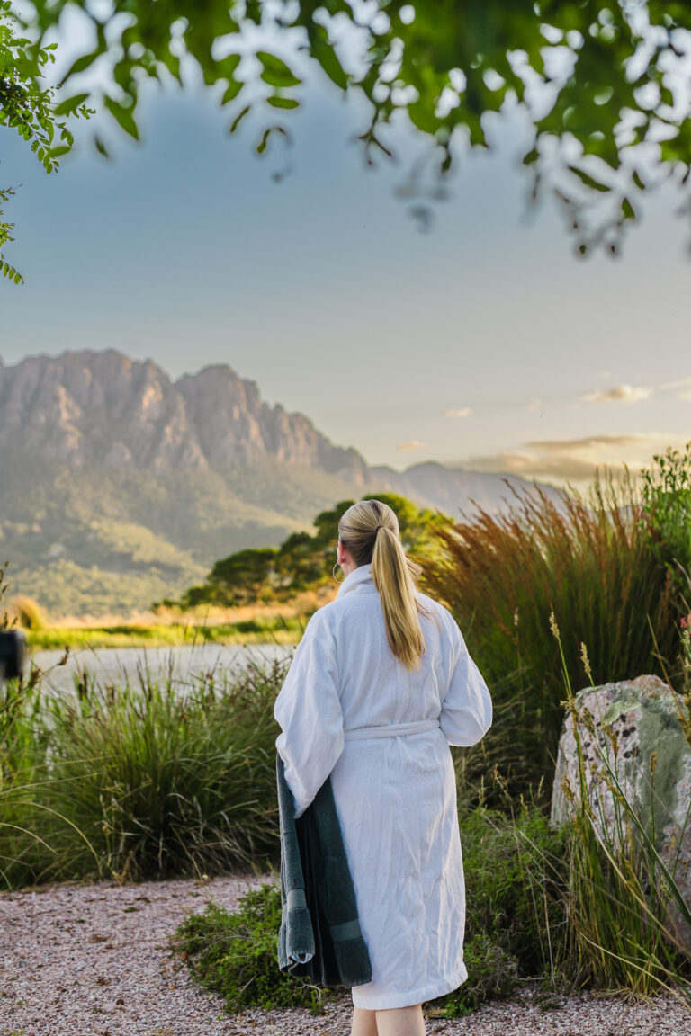 Guest enjoying an outdoor bath overlooking the mountains in North West Tasmania.