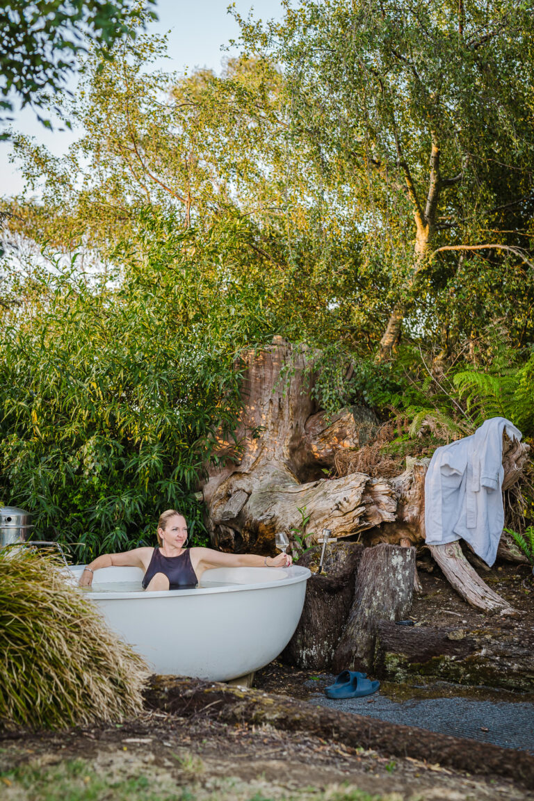 Guest enjoying an outdoor bath overlooking the mountains in North West Tasmania.